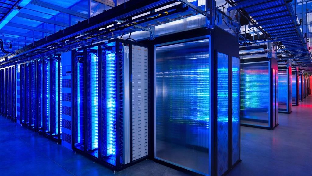 Rows of server racks lit blue in a data centre